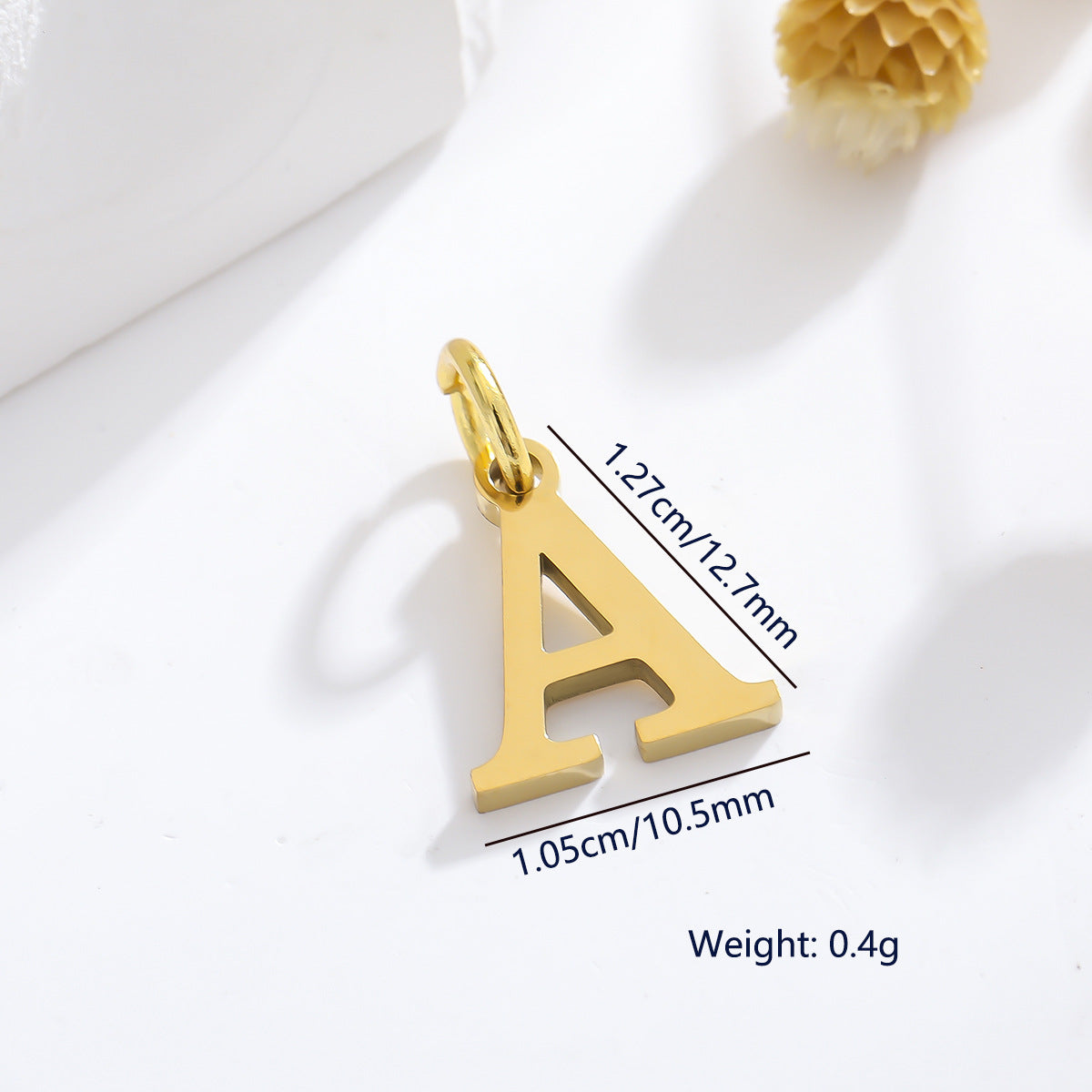 Dijes de letras de acero