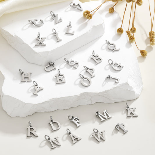 Dijes de letras de acero